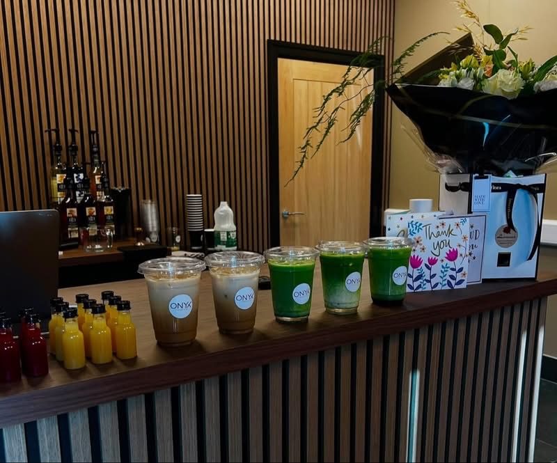 Matcha lattes and syrups on the walnut counter of the Onyx refuel bar in Auckley, Doncaster